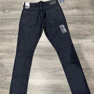 Blue Skinny Jeans with Deep Indigo Color and Visible Stitching